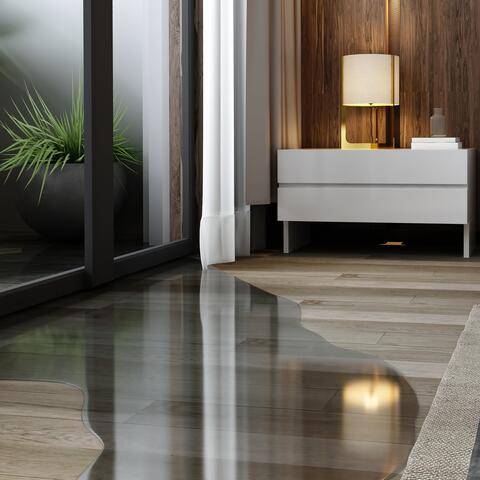 Water seeping from the patio door onto a bedroom’s wooden floor; bedside table and plant in the background.